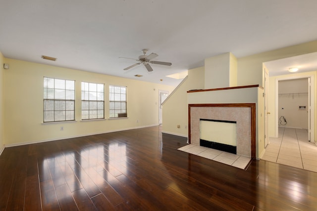 unfurnished living room with a fireplace, light hardwood / wood-style floors, and ceiling fan