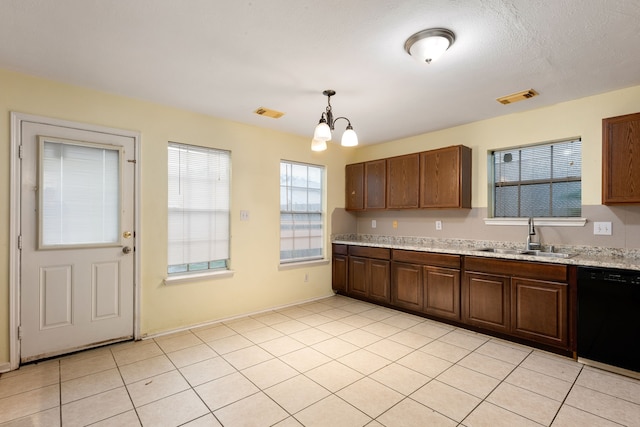 kitchen with light stone counters, black dishwasher, pendant lighting, an inviting chandelier, and sink