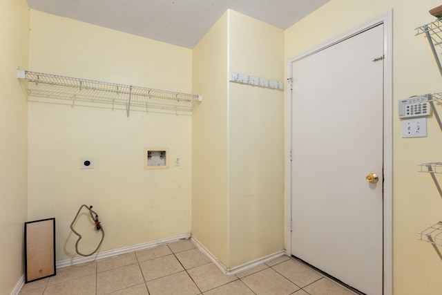 laundry area featuring washer hookup, electric dryer hookup, and light tile patterned flooring