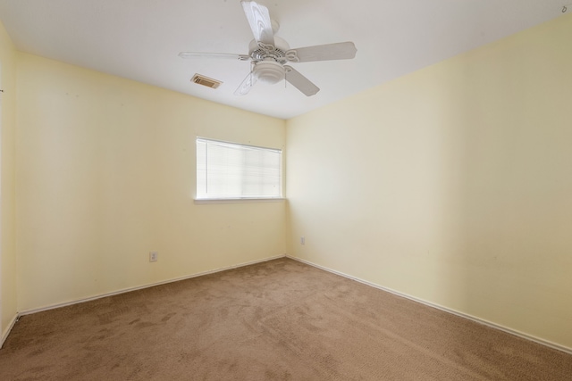 empty room featuring carpet flooring and ceiling fan