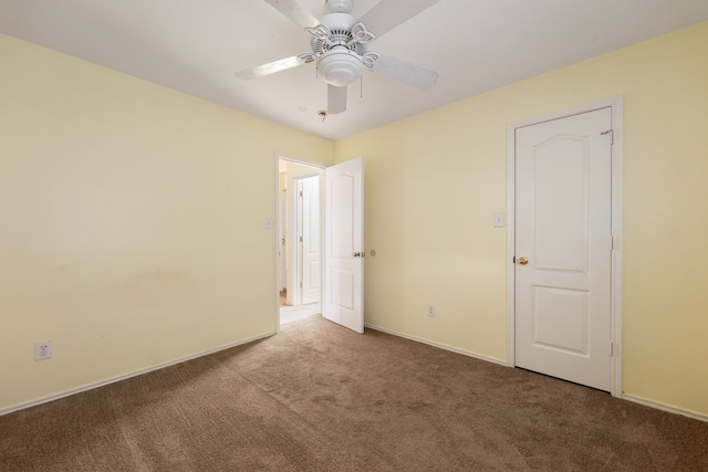 unfurnished room featuring ceiling fan and carpet floors