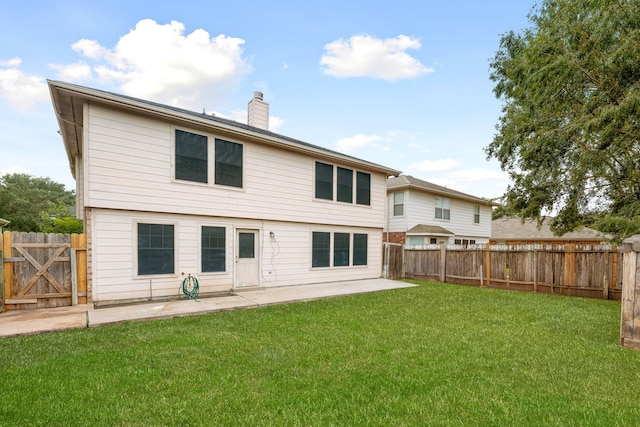 back of property with a yard and a patio area