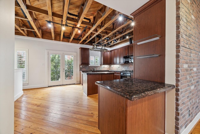 kitchen featuring wood ceiling, kitchen peninsula, a kitchen island, decorative backsplash, and light hardwood / wood-style flooring