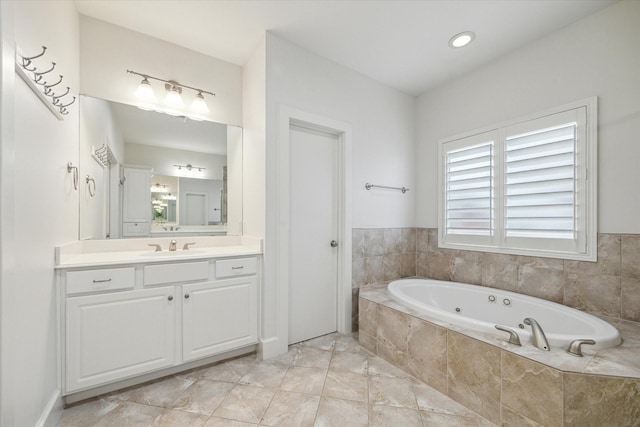 bathroom with a relaxing tiled tub and vanity