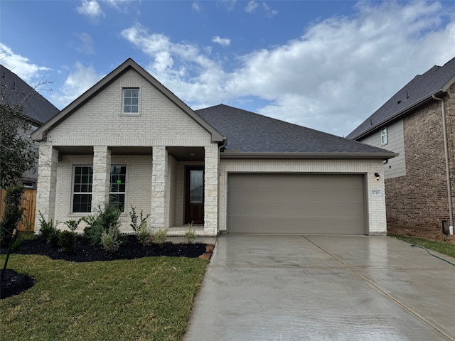 view of front of home featuring a garage and a front lawn