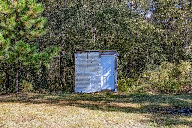 view of outdoor structure with a lawn