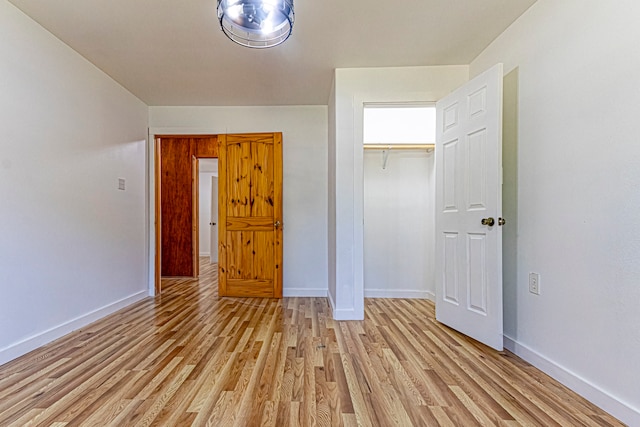 unfurnished bedroom featuring a closet and light hardwood / wood-style flooring