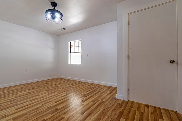 unfurnished room with light hardwood / wood-style floors