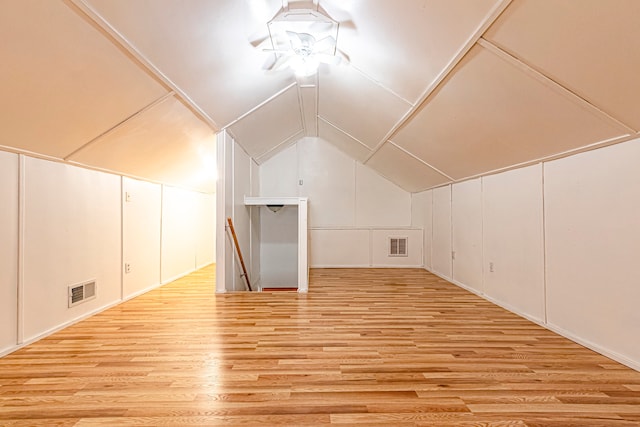 additional living space featuring light wood-type flooring, ceiling fan, and vaulted ceiling