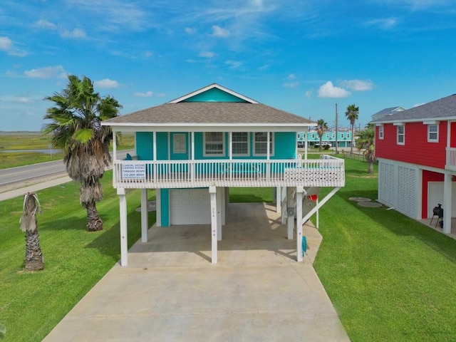 view of front facade featuring a garage, a front lawn, and a carport