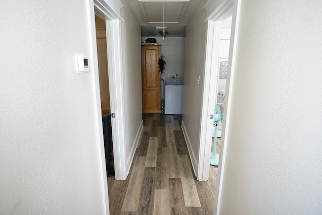 hall with hardwood / wood-style flooring and washer / clothes dryer