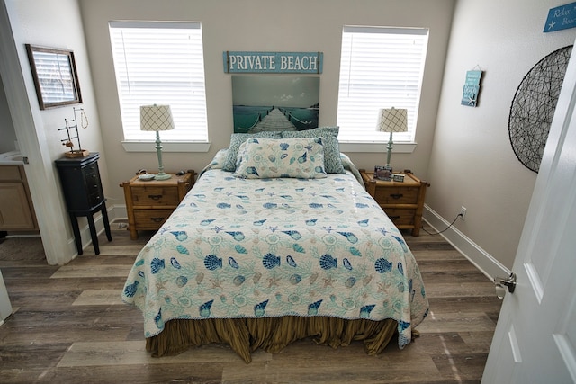 bedroom featuring dark hardwood / wood-style flooring and multiple windows