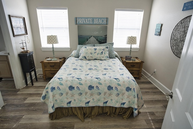 334 Sand Dune Ct, Surfside Beach, TX 77541 - bedroom with dark wood finished floors, multiple windows, and baseboards