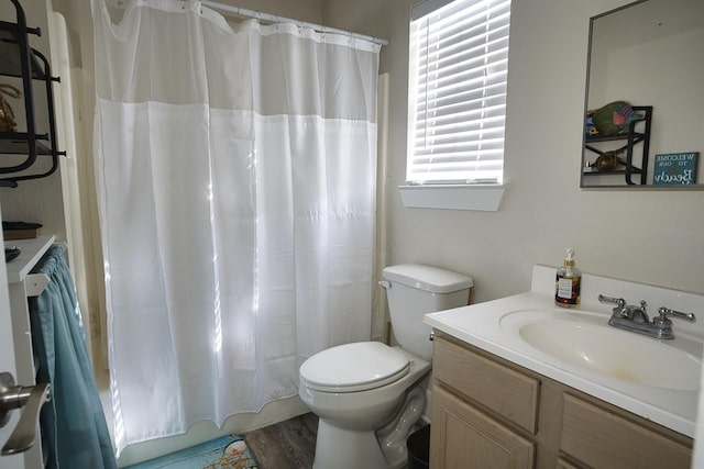 334 Sand Dune Ct, Surfside Beach, TX 77541 - full bathroom with toilet, vanity, shower / bath combo with shower curtain, and wood finished floors