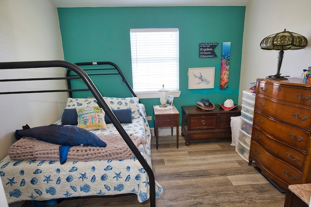 bedroom with hardwood / wood-style flooring