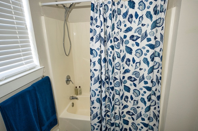 bathroom with shower / bath combo with shower curtain