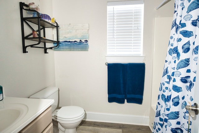 full bathroom featuring hardwood / wood-style flooring, plenty of natural light, vanity, and toilet