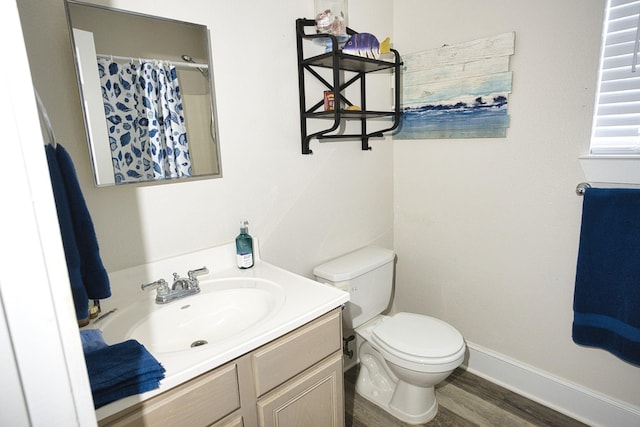 334 Sand Dune Ct, Surfside Beach, TX 77541 - bathroom with toilet, wood finished floors, vanity, baseboards, and curtained shower