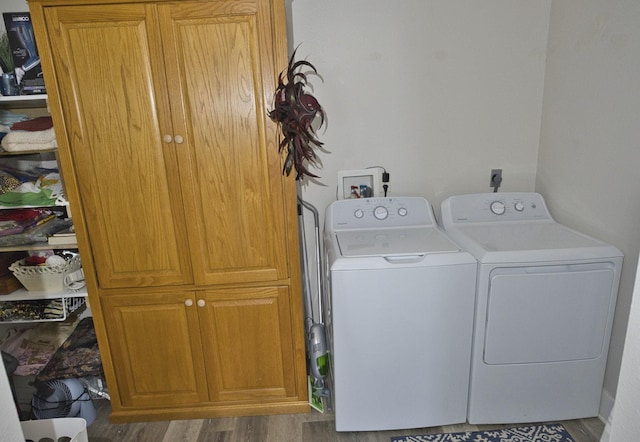 334 Sand Dune Ct, Surfside Beach, TX 77541 - washroom featuring cabinet space, separate washer and dryer, and wood finished floors