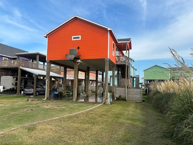 rear view of house featuring a lawn