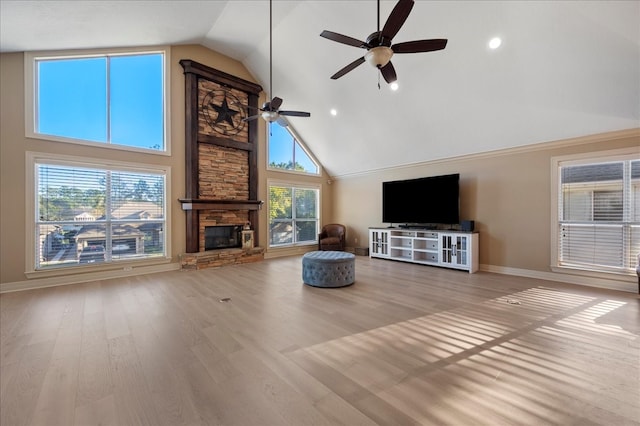 unfurnished living room featuring ceiling fan, a fireplace, high vaulted ceiling, and light hardwood / wood-style floors