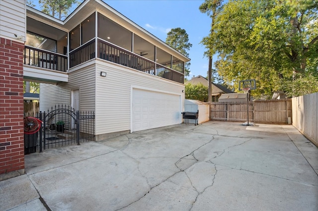 view of home's exterior with a garage and a sunroom