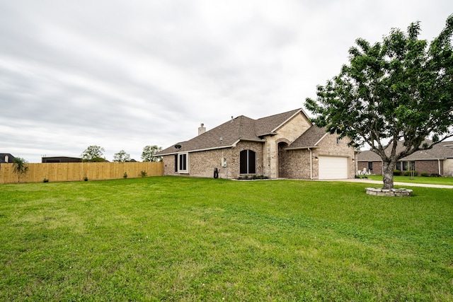 french country inspired facade with a garage and a front lawn