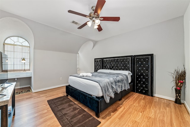 bedroom featuring hardwood / wood-style floors, ceiling fan, and lofted ceiling