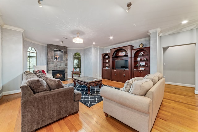 living room with a stone fireplace, light wood-type flooring, and crown molding