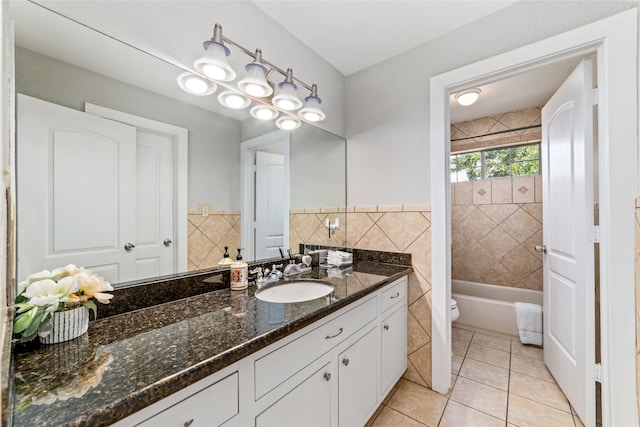 full bathroom featuring tile walls, vanity, tile patterned floors, and toilet