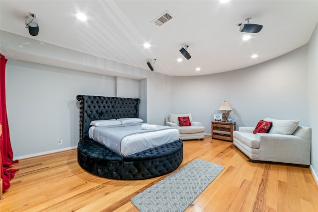 bedroom with hardwood / wood-style floors