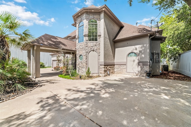 rear view of property featuring cooling unit and a carport