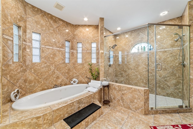 bathroom featuring tile walls and independent shower and bath