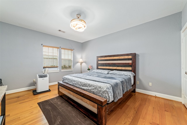 bedroom with wood-type flooring