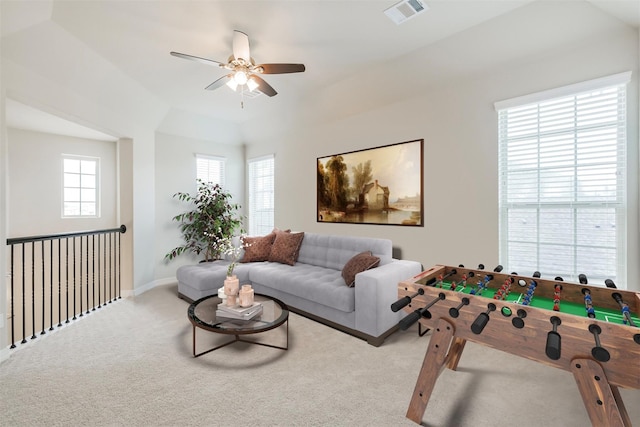 carpeted living room with ceiling fan