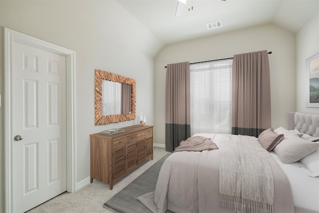 bedroom featuring lofted ceiling, ceiling fan, and light carpet