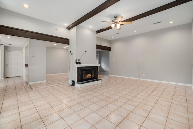 unfurnished living room with beamed ceiling, light tile patterned floors, and ceiling fan