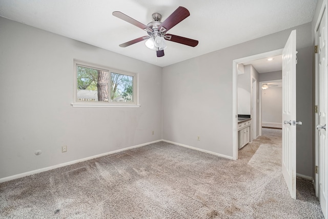 empty room featuring light colored carpet and ceiling fan