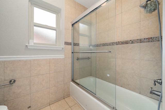 bathroom featuring tile patterned flooring and enclosed tub / shower combo