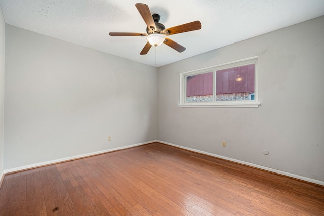 empty room with ceiling fan and wood-type flooring