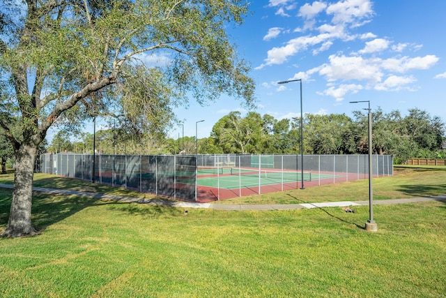 view of sport court featuring a yard