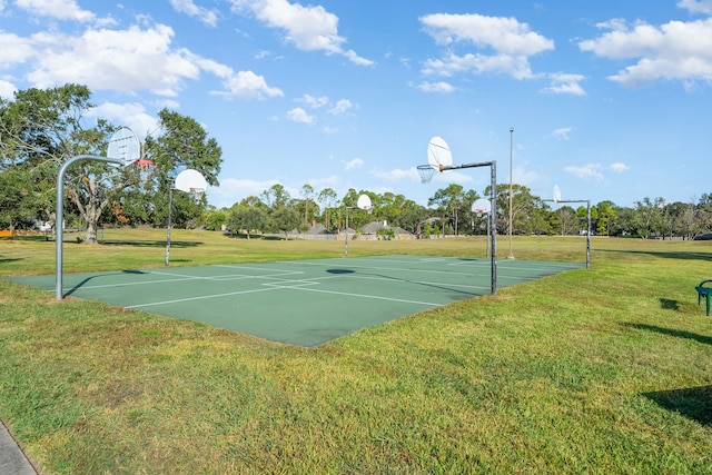 view of basketball court with a yard