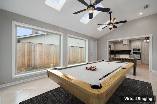 playroom with lofted ceiling with skylight, light tile patterned floors, and pool table