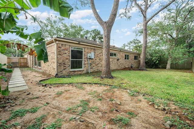 rear view of house with a lawn