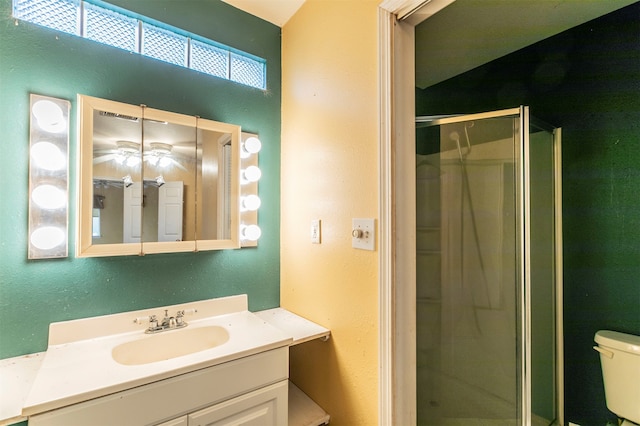 bathroom with walk in shower, vanity, and toilet