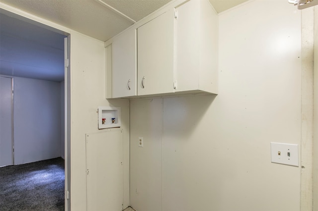 laundry room featuring washer hookup, cabinets, and carpet flooring