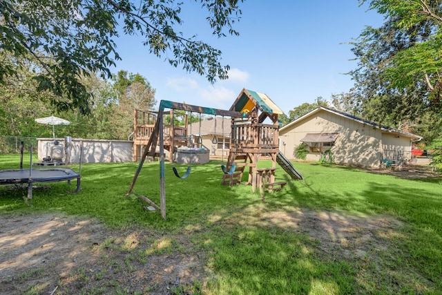 view of jungle gym with a lawn and a trampoline