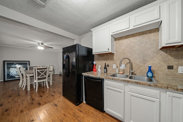 kitchen with black appliances, backsplash, sink, hardwood / wood-style floors, and white cabinets