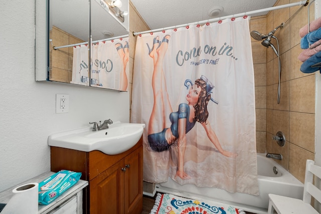 bathroom featuring a textured ceiling, vanity, and shower / bath combo with shower curtain