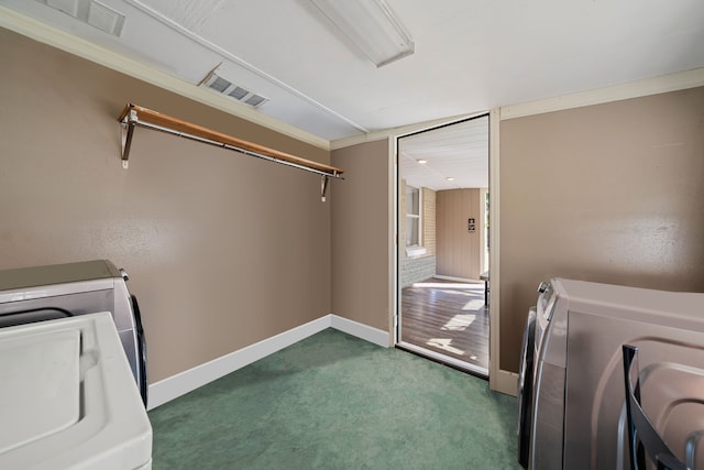 washroom featuring washing machine and dryer and dark carpet